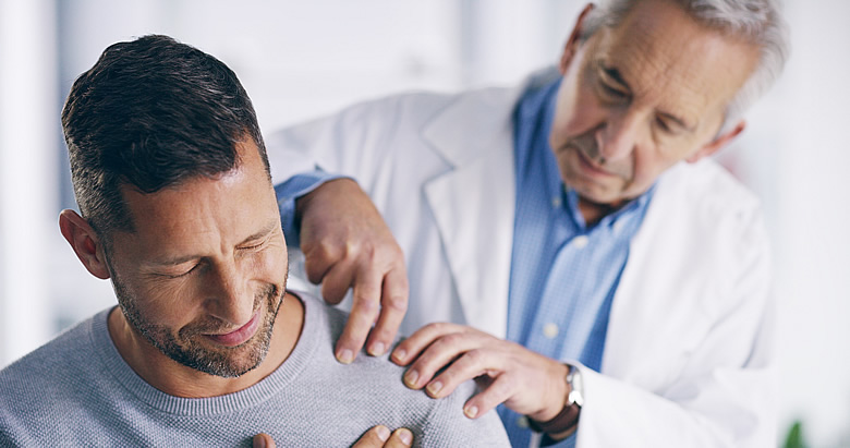 Man with Pain in Doctor's Office