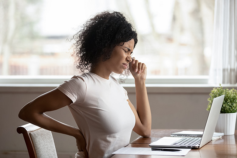 Woman with Back Pain at Desk